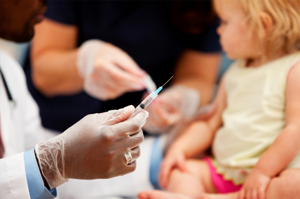 Copil la cabinetul medicului primind vaccin