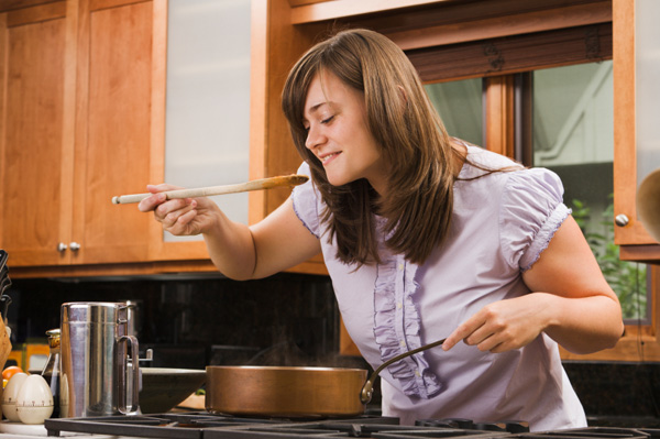 Nő főzés serpenyőben