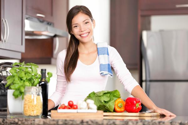 Donna felice che cucina a casa